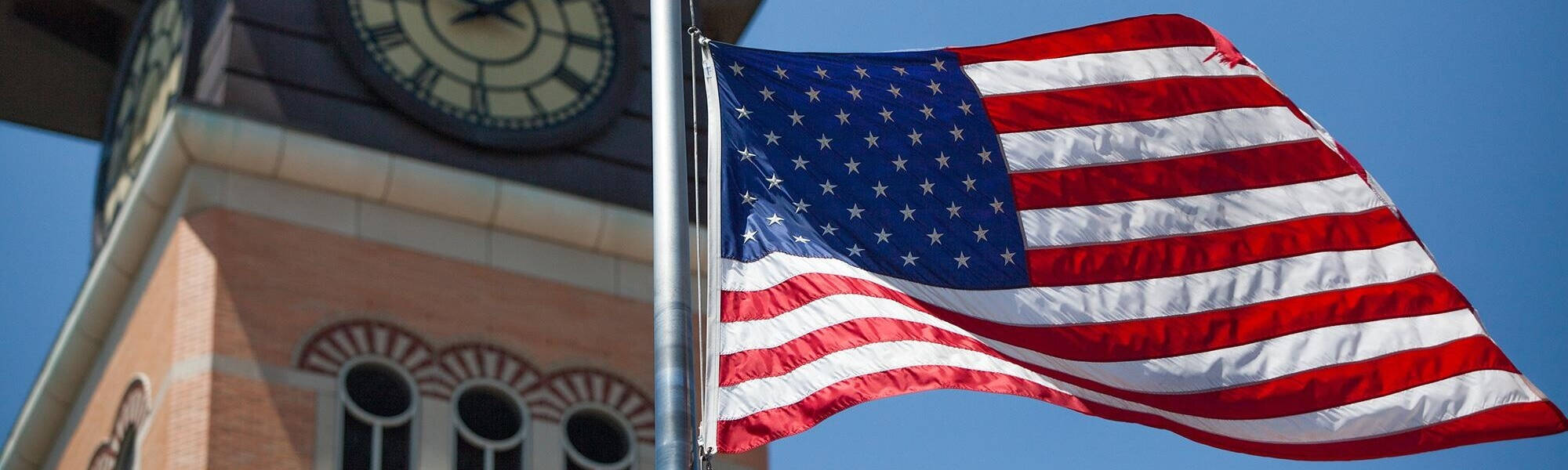 American Flag with GVSU Clocktower in Background